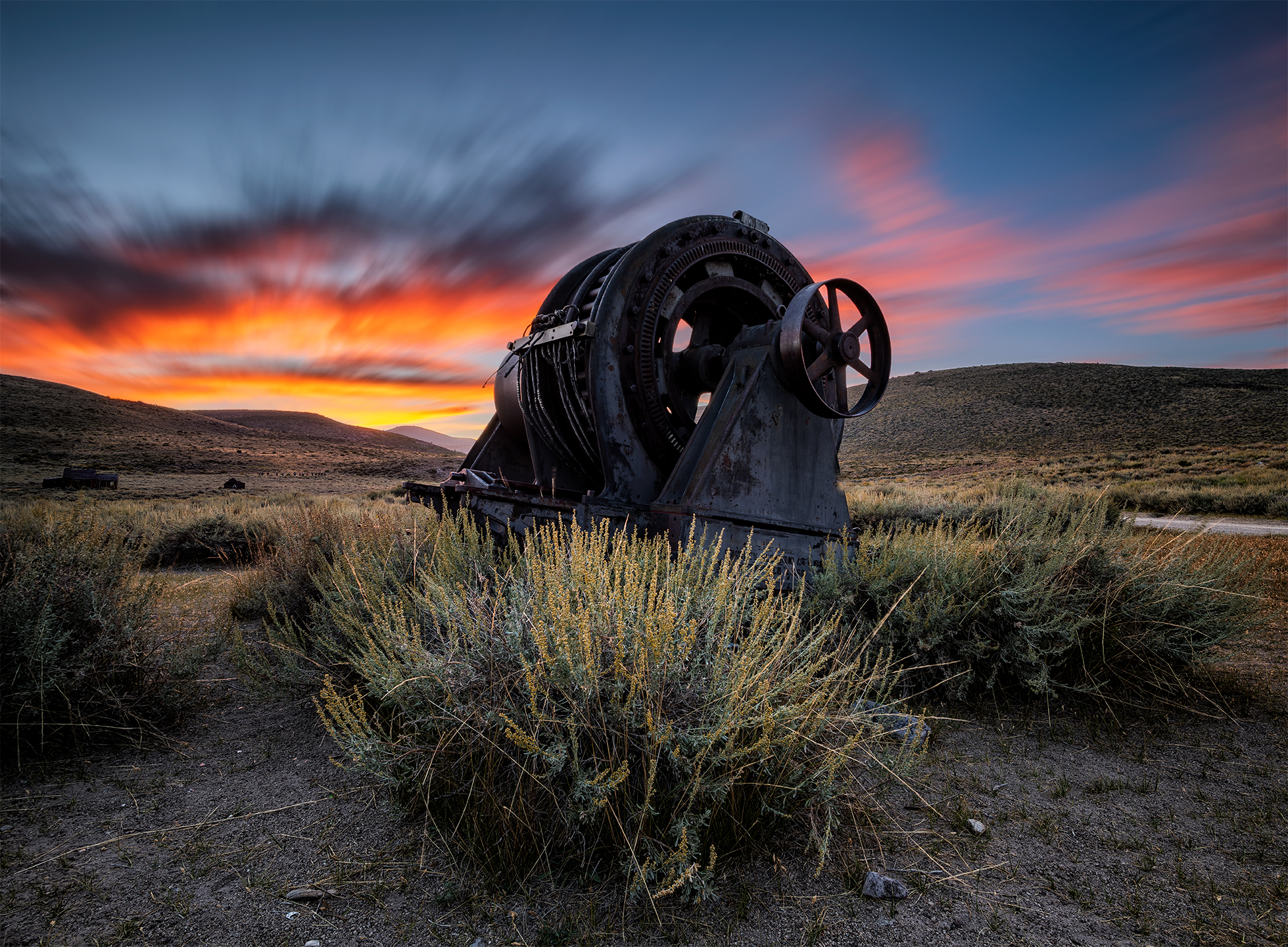 Old gear shaft in the wilderness at sunset