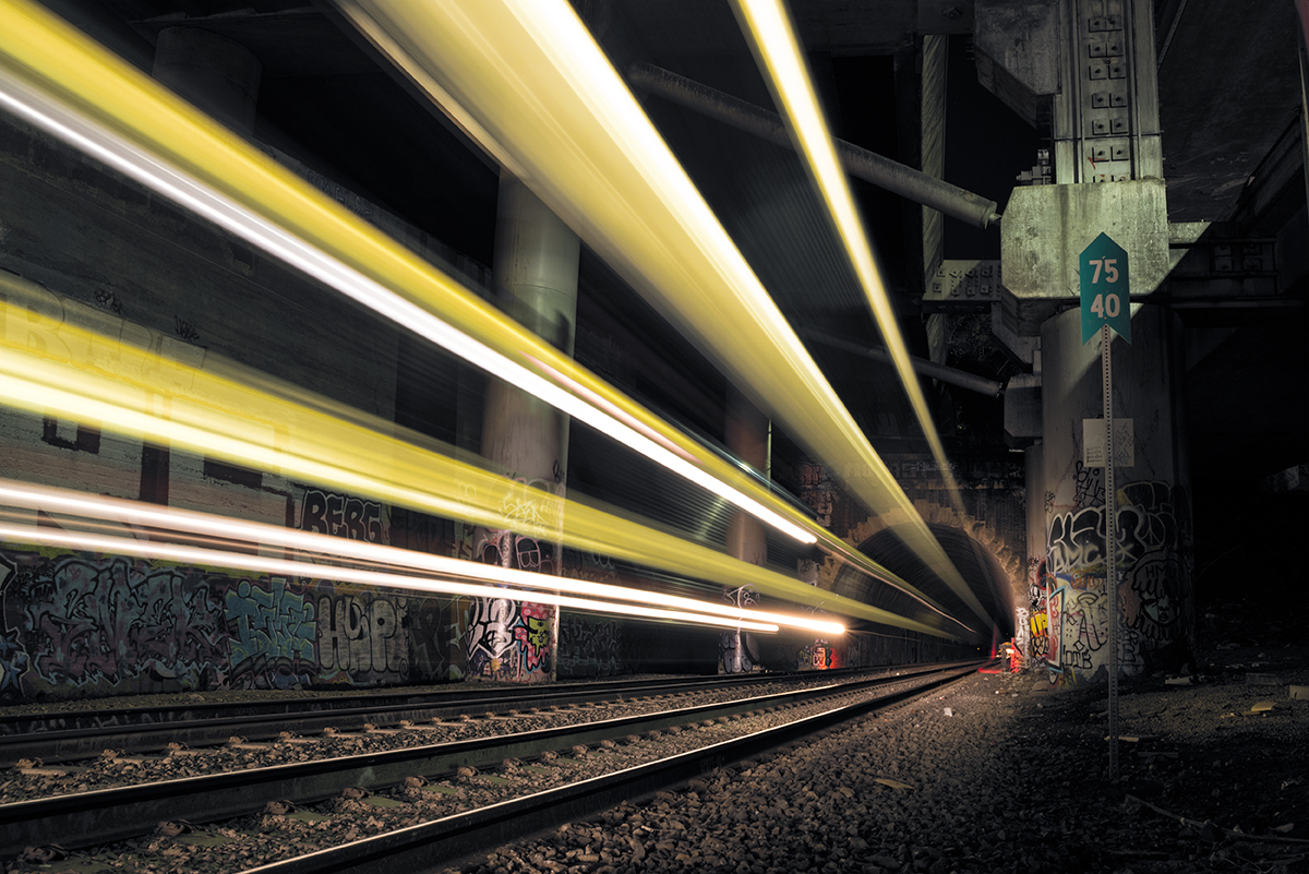 Light trails from the train burst out of the train tunnel from downtown SF at night