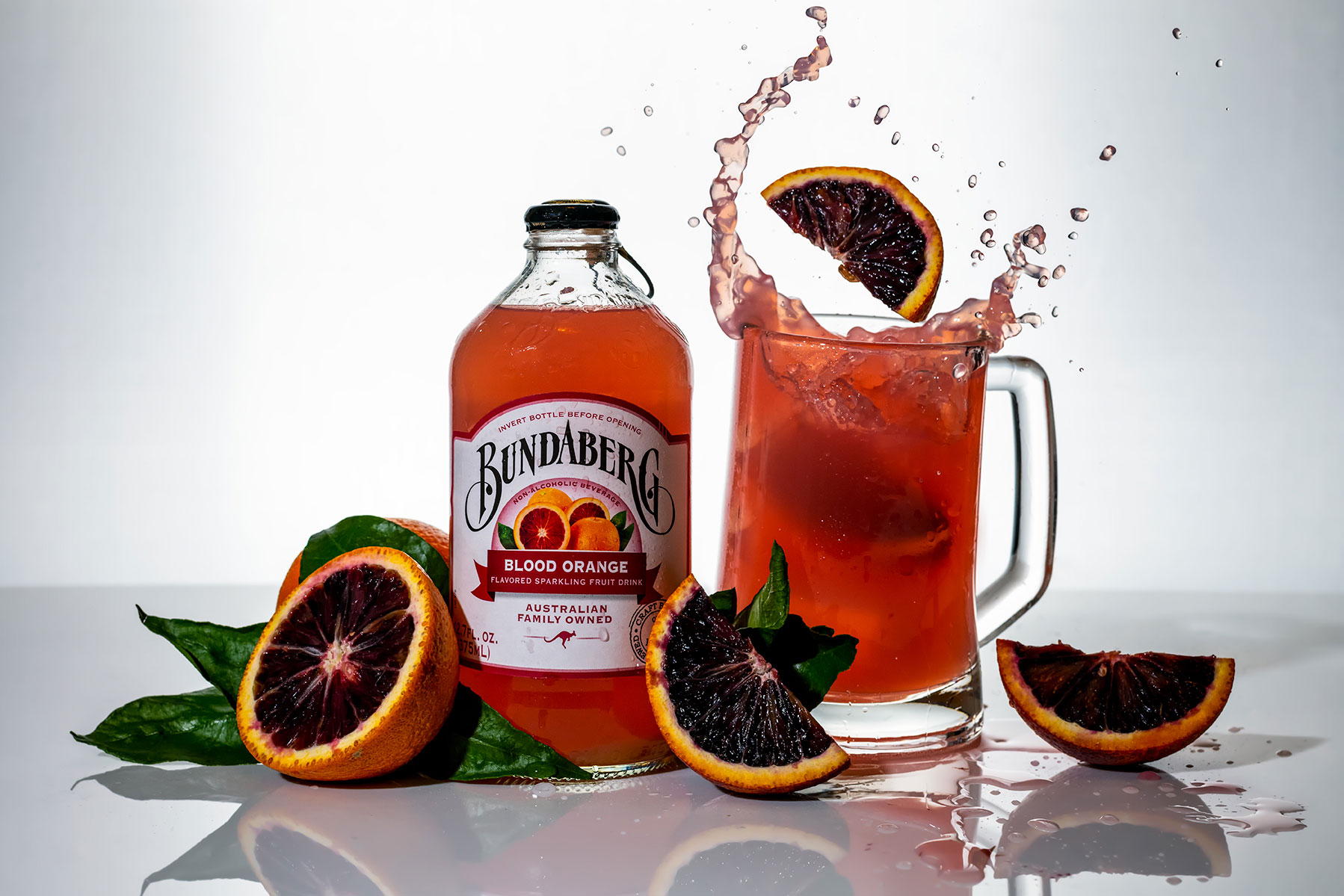 Product splash photography of Bundaberg soda and glassware
